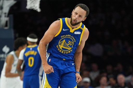 Golden State Warriors guard Stephen Curry (30) celebrates after making a 3-point shot during the first half of an NBA basketball game against the Minnesota Timberwolves, Wednesday, Oct. 28, 2026, in Minneapolis. (AP Photo/Abbie Parr)