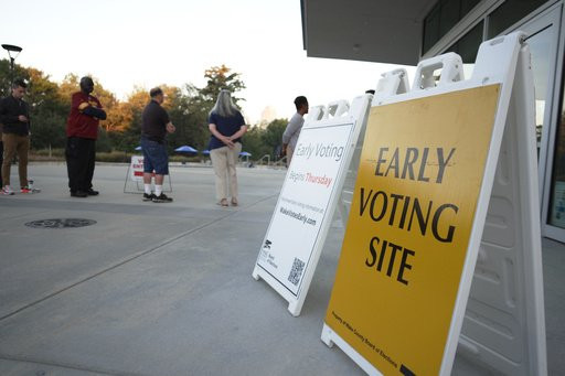 People line up outside the John Chavis Memorial Park center for the first day of early voting in Raleigh, N.C., on Thursday, Oct. 15, 2026. (AP Photo/Allen G. Breed)