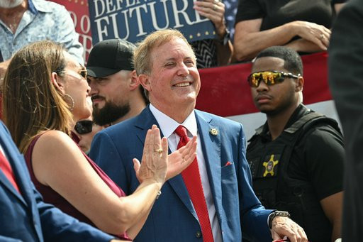 Texas Attorney General and Republican Senate candidate Ken Paxton smiles as Vice President JD Vance speaks during a campaign rally at Tyler Pounds Regional Airport in Tyler, Texas, Tuesday, Oct. 13, 2026. (Saul Loeb/Pool Photo via AP, File)