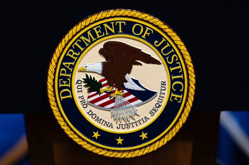 FILE - The U.S. Department of Justice logo is seen on a podium before a news conference, May 4, 2026, in Washington. (AP Photo/Julia Demaree Nikhinson, File)