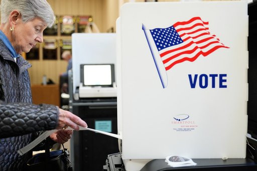 A woman feeds her ballot into a scanning machine at an early voting site in Haverstraw, N.Y., Monday, Oct. 26, 2026. (AP Photo/Seth Wenig)