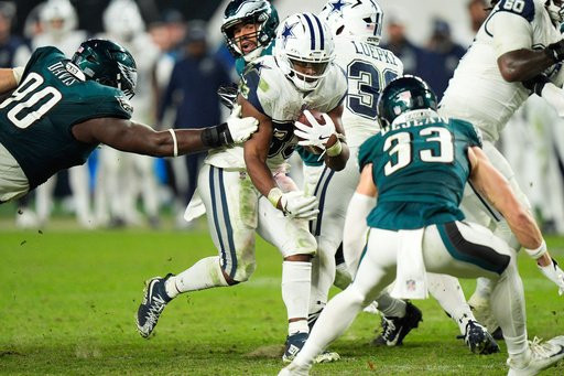 Dallas Cowboys running back Javonte Williams (33) runs for a first down during the second half of an NFL football game against the Philadelphia Eagles in Philadelphia, Monday, Oct. 26, 2026. (AP Photo/Chris Szagola)