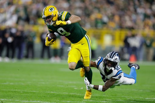 Green Bay Packers wide receiver Christian Watson (9) is hit by Carolina Panthers safety Zakee Wheatley as he catches a pass for a first down during the first half of an NFL football game in Green Bay, Wis., Thursday, Oct. 29, 2026. (AP Photo/Matt Ludtke)