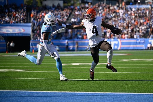 Cleveland Browns quarterback Deshaun Watson (4) holds off Tennessee Titans safety Kevin Winston Jr. (23) on his way to scoring a touchdown during the second half of an NFL football game in Nashville, Tenn., Sunday, Oct. 25, 2026. (AP Photo/John Amis)
