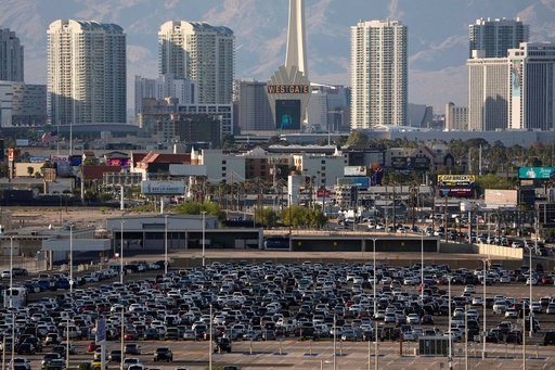 FILE - Cars fill a lot at Harry Reid International Airport near the Las Vegas Strip, April 9, 2025, in Las Vegas. (AP Photo/John Locher, File)