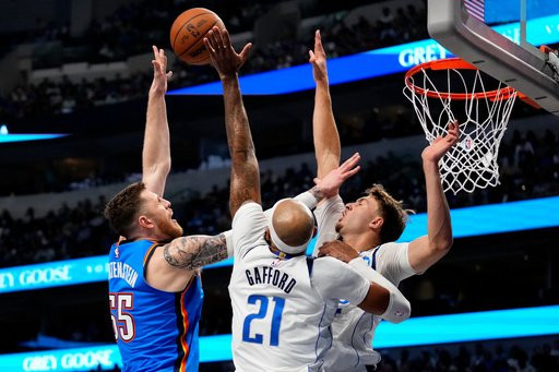 Oklahoma City Thunder center Isaiah Hartenstein (55) shoots over Dallas Mavericks forward Daniel Gafford (21) and forward Cooper Flagg during the first half of an NBA basketball game Wednesday, Oct. 28, 2026, in Dallas. (AP Photo/Jeffrey McWhorter)