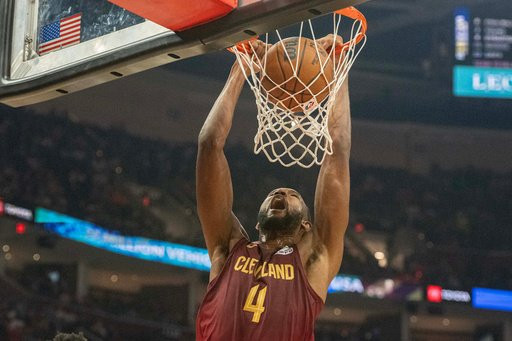 Cleveland Cavaliers' Evan Mobley (4) dunks against the Washington Wizards during the first half of an NBA basketball game in Cleveland, Wednesday, Oct. 28, 2026. (AP Photo/Phil Long)