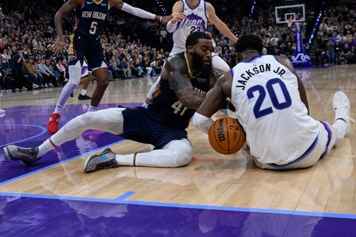 New Orleans Pelicans guard Saddiq Bey (41) and Utah Jazz forward Jaren Jackson Jr. (20) fight for possession of the loose ball during the final minute of play during an NBA basketball game, Friday, Oct. 23, 2026, in Salt Lake City. (AP Photo/Tyler Tate)