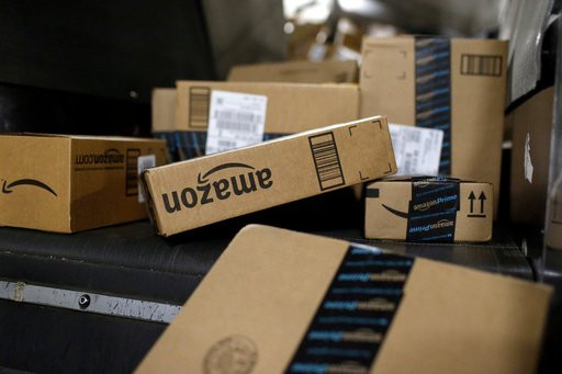 FILE - Packages in Amazon boxes move along a conveyor belt at the UPS Worldport hub in Louisville, Ky., Nov. 20, 2015. (AP Photo/Patrick Semansky, File)