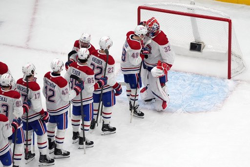 Montreal Canadiens goaltender Jacob Fowler (32) is congratulated by teammates after earning a shutout victory over the St. Louis Blues an NHL hockey game Tuesday, Oct. 27, 2026, in St. Louis. (AP Photo/Jeff Roberson)