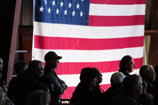 Attendees listen as Republican U.S. Senate candidate Texas Attorney General Ken Paxton speaks at a event kicking off his campaign's bus tour during an event at the Rockwall Municipal Airport Saturday, Oct. 17, 2026, in Rockwall, Texas. (AP Photo/Tony Gutierrez)