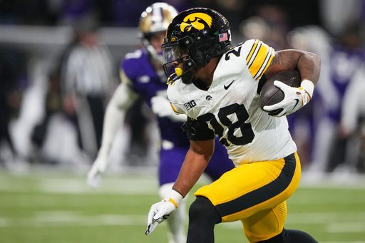 Iowa running back Kamari Moulton rushes against Washington during the second half of an NCAA college football game, Friday, Oct. 9, 2026, in Seattle. (AP Photo/Lindsey Wasson)