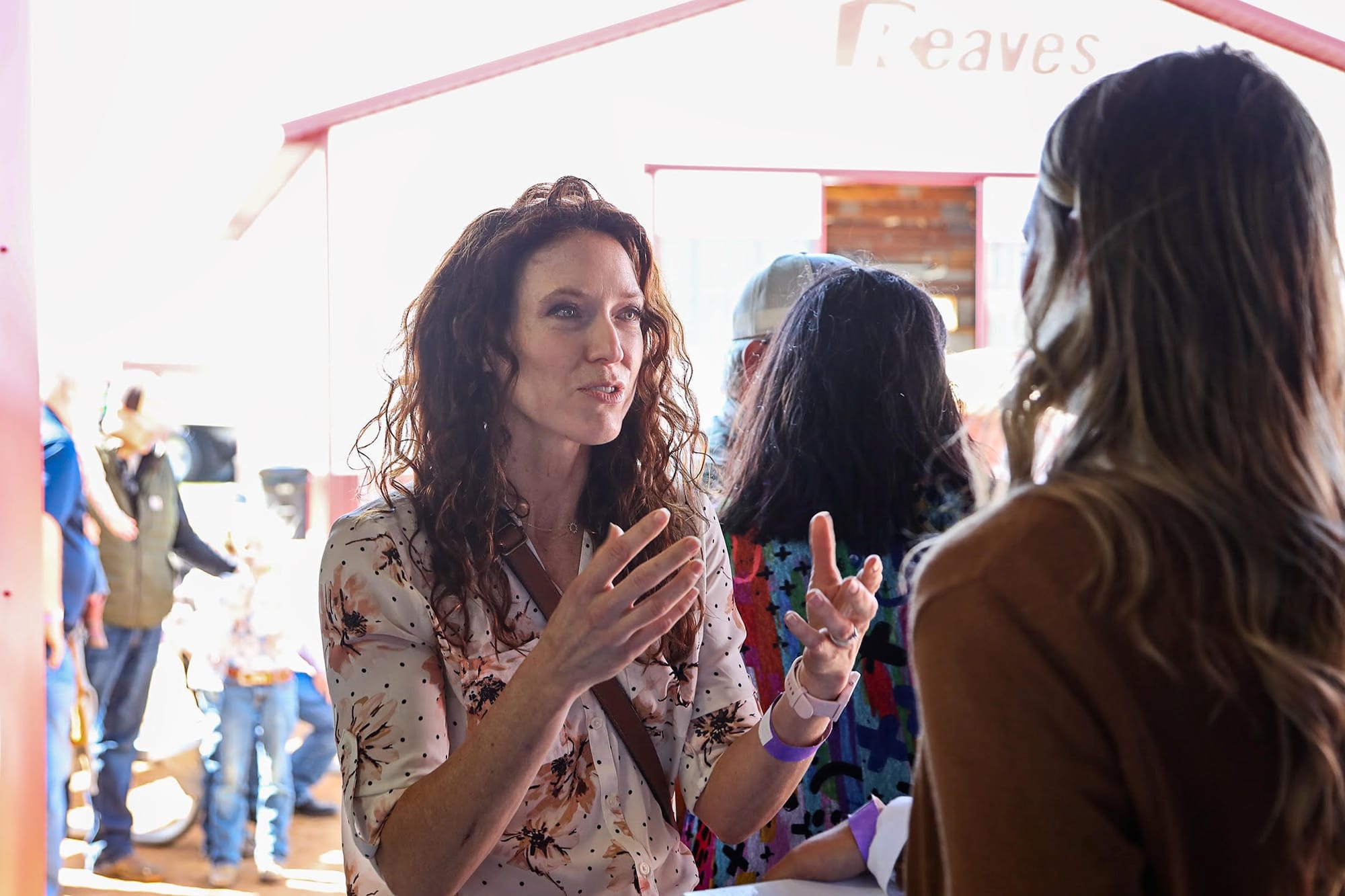 A woman gestures while talking to another woman at Dakotafest in Mitchell.