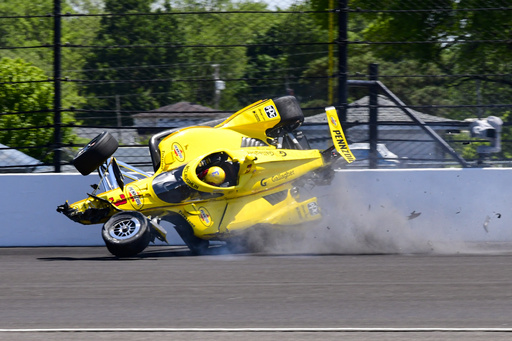 The car driven by Scott McLaughlin, of New Zealand, becomes airborne after hitting the wall in the second turn during practice for the Indianapolis 500 auto race at Indianapolis Motor Speedway in Indianapolis, Sunday, May 18, 2025. (AP Photo/John Maxwell)
