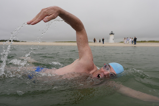 Endurance swimmer Lewis Pugh swims near the Edgartown Harbor Light, Thursday, May 15, 2025, in Edgartown, Mass. (AP Photo/Robert F. Bukaty)