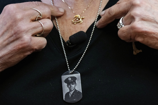 Diane Christie wears a necklace with a photograph of her uncle, World War II U.S. Army Air Forces 2nd Lt. Thomas Kelly, inside Santos Robinson Mortuary, Friday, May 23, 2025, in San Leandro, Calif., whose remains had been missing since being killed when the World War II bomber nicknamed Heaven Can Wait was hit by anti-aircraft fire and crashed into the water off the coast of New Guinea on March 11, 1944. (AP Photo/Godofredo A. Vásquez)