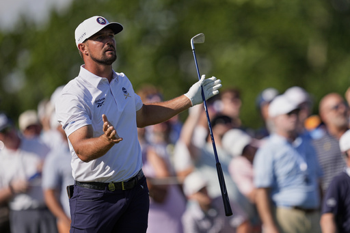 Bryson DeChambeau reacts after hitting his tee shot into the water on the 17th hole during the third round of the PGA Championship golf tournament at the Quail Hollow Club, Saturday, May 17, 2025, in Charlotte, N.C. (AP Photo/George Walker IV)