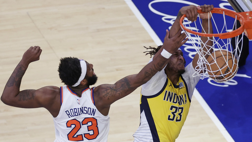 Indiana Pacers center Myles Turner (33) dunks the ball against New York Knicks center Mitchell Robinson (23) during the third quarter of Game 2 of the NBA basketball Eastern Conference final, Friday, May 23, 2025, in New York. (AP Photo/Adam Hunger)