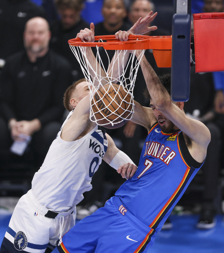 Oklahoma City Thunder forward Chet Holmgren (7) dunks on Minnesota Timberwolves guard Donte DiVincenzo (0) during the second half of Game 2 of an NBA basketball Western Conference Finals playoff series Thursday, May 22, 2025, in Oklahoma City. (AP Photo/Nate Billings)