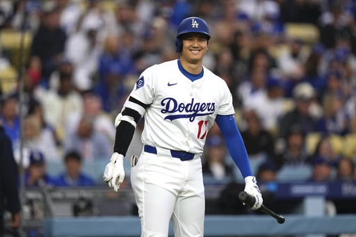 Los Angeles Dodgers' Shohei Ohtani smiles toward the Los Angeles Angels dugout before batting during the first inning of a baseball game Friday, May 16, 2025, in Los Angeles. (AP Photo/Mark J. Terrill)