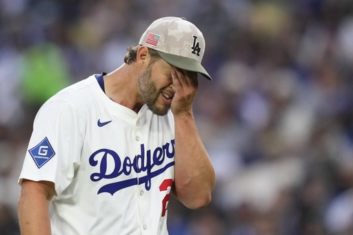 Los Angeles Dodgers starting pitcher Clayton Kershaw wipes his face after the top of the third inning of a baseball game against the Los Angeles Angels, Saturday, May 17, 2025, in Los Angeles. (AP Photo/Mark J. Terrill)