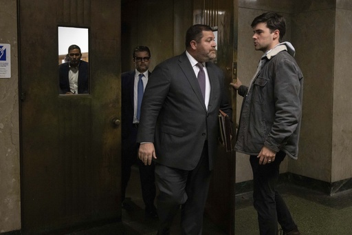 Wayne Gosnell, center, attorney for John Woeltz, cryptocurrency investor charged for kidnapping and false imprisonment, exits a courtroom, Wednesday, May 28, 2025, in New York. (AP Photo/Yuki Iwamura)
