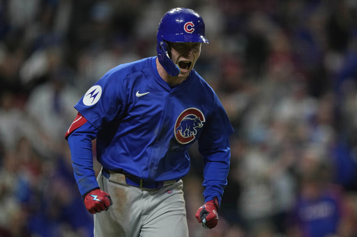 Chicago Cubs' Pete Crow-Armstrong reacts after hitting a grand slam to right field during the seventh inning of a baseball game against the Cincinnati Reds, Friday, May 23, 2025, in Cincinnati. (AP Photo/Carolyn Kaster)
