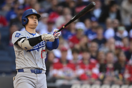 Los Angeles Dodgers' Shohei Ohtani reacts after swinging at a pitch during the second inning of a baseball game against the Cleveland Guardians, Monday, May 26, 2025, in Cleveland. (AP Photo/David Dermer)