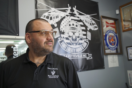 Ralph Rodriguez poses for a portrait at his pawn and gun shop in Fayetteville, N.C., Friday, May 9, 2025. (AP Photo/Allen G. Breed)