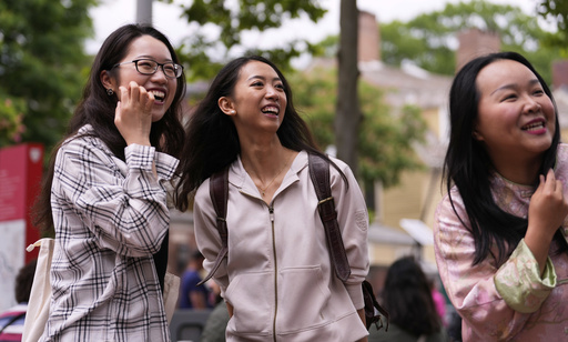 Yurong "Luanna" Jiang, center, who delivered a speech at her Harvard University commencement, jokes with her college friends Helen Ji, left, and Cynthia Luo, Friday, May 30, 2025, in Cambridge, Mass. (AP Photo/Charles Krupa)