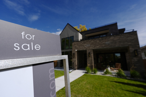 FILE - A sale sign stands outside a home on the market Thursday, Oct. 17, 2024, in the east Washington Park neighborhood of Denver. (AP Photo/David Zalubowski, File)