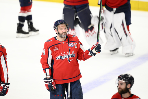 Washington Capitals left wing Alex Ovechkin (8) raises his stick to the crowd after Game 5 of a second-round NHL hockey playoff series against the Carolina HurricanesThursday, May 15, 2025, in Washington. (AP Photo/Nick Wass)