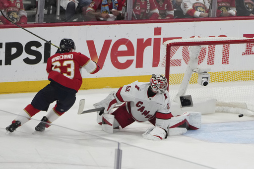 Florida Panthers' Brad Marchand (63) reacts after scoring a goal against Carolina Hurricanes goaltender Pyotr Kochetkov (52) during the third period in Game 3 of the NHL hockey Stanley Cup Eastern Conference finals Saturday, May 24, 2025, in Sunrise, Fla. (AP Photo/Lynne Sladky)
