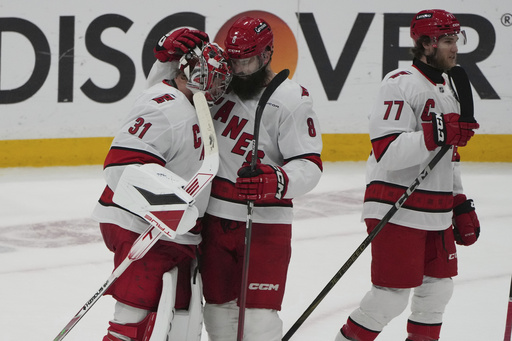 Carolina Hurricanes goaltender Frederik Andersen (31) and defenseman Brent Burns (8) celebrate at the end of the third period in Game 4 of the NHL hockey Stanley Cup Eastern Conference finals against the Florida Panthers, Monday, May 26, 2025, in Sunrise, Fla. (AP Photo/Lynne Sladky)