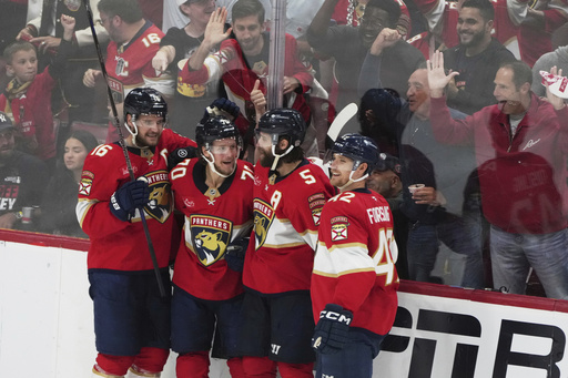 Florida Panthers center Jesper Boqvist (70) celebrates with Aleksander Barkov (16), Aaron Ekblad (5) and Gustav Forsling (42) after scoring a goal against the Carolina Hurricanes during the third period in Game 3 of the NHL hockey Stanley Cup Eastern Conference finals Saturday, May 24, 2025, in Sunrise, Fla. (AP Photo/Lynne Sladky)