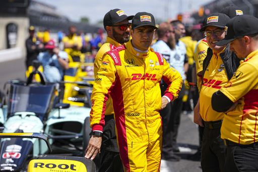 Alex Palou, of Spain, talks with his crew as he waits for is turn during qualification for the Indianapolis 500 auto race at Indianapolis Motor Speedway in Indianapolis, Saturday, May 17, 2025. (AP Photo/Michael Conroy)