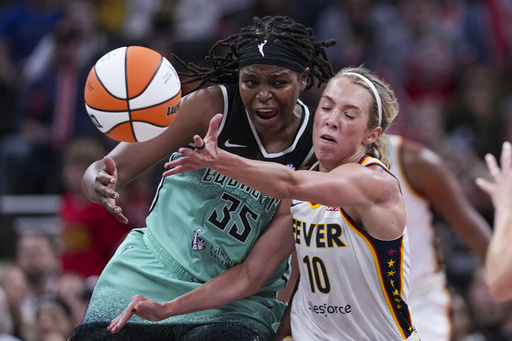 New York Liberty center Jonquel Jones (35) and Indiana Fever guard Lexie Hull (10) go for a loose ball in the second half of a WNBA basketball game in Indianapolis, Saturday, May 24, 2025. (AP Photo/Michael Conroy)