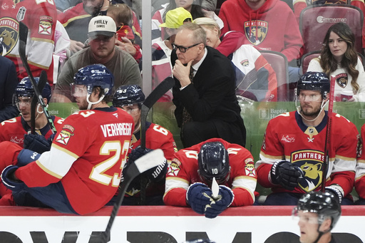 Florida Panthers head coach Paul Maurice, center, rear, talks with players during the third period in Game 6 of a second-round NHL hockey playoff series against the Toronto Maple Leafs, Friday, May 16, 2025, in Sunrise, Fla. (AP Photo/Lynne Sladky)