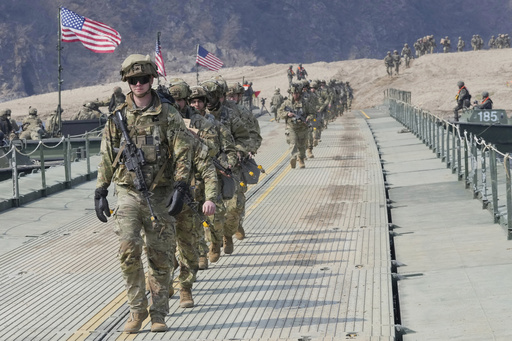 FILE - U.S. Army soldiers cross a floating bridge on the Imjin River during a joint river-crossing exercise between South Korea and the United States as a part of the Freedom Shield military exercise in Yeoncheon, South Korea, March 20, 2025. (AP Photo/Ahn Young-joon, File)