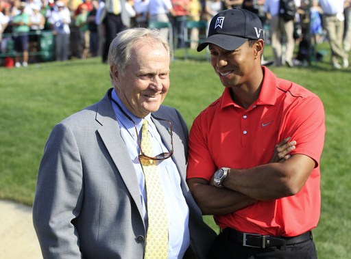 FILE - In this Sunday, June 3, 2012, file photo, Jack Nicklaus, left, talks with Tiger Woods after Woods won the Memorial golf tournament at the Muirfield Village Golf Club in Dublin, Ohio. (AP Photo/Tony Dejak, File)