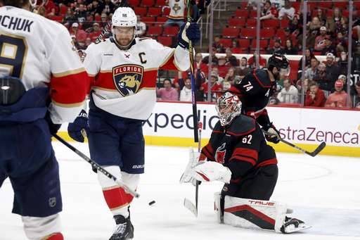 Florida Panthers' Aleksander Barkov, right, celebrates his goal with Florida Panthers' Matthew Tkachuk (19) as Carolina Hurricanes goaltender Pyotr Kochetkov (52) looks on during the third period of Game 2 of the NHL hockey Stanley Cup Eastern Conference finals in Raleigh, N.C., Thursday, May 22, 2025. (AP Photo/Karl DeBlaker)
