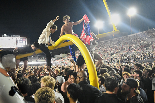 FILE - Vanderbilt fans climb a goalpost as they celebrate on the field after defeating Alabama in an NCAA football game, Saturday, Oct. 5, 2024, in Nashville, Tenn. (AP Photo/John Amis, File)