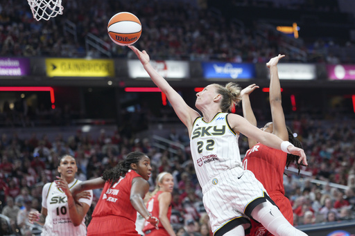 Chicago Sky guard Courtney Vandersloot (22) shoots in front pf Indiana Fever guard Kelsey Mitchell (0) during the first half of a WNBA basketball game in Indianapolis, Saturday, May 17, 2025. (AP Photo/AJ Mast)