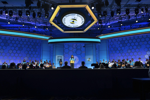 Sydney Tamhnu Tran, 13, of Irvine, Calif., spells her word as she competes during the first preliminary round of the Scripps National Spelling Bee at the Gaylord National Resort & Convention Center, Tuesday, May 27, 2025, in Oxon Hill, Md. (AP Photo/Jose Luis Magana)
