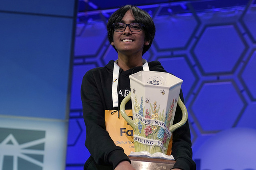 Faizan Zaki, 13, of Dallas, holds the trophy after winning the 2025 Scripps National Spelling Bee at the Gaylord National Resort & Convention Center Thursday, May 29, 2025, in Oxon Hill, Md. (AP Photo/Jose Luis Magana)