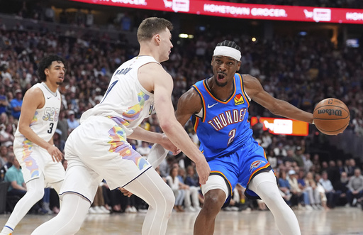Oklahoma City Thunder guard Shai Gilgeous-Alexander, right, drives to the basket as Denver Nuggets guard Christian Braun defends in the second half of Game 6 in the Western Conference semifinals of the NBA basketball playoffs Thursday, May 15, 2025, in Denver. (AP Photo/David Zalubowski)