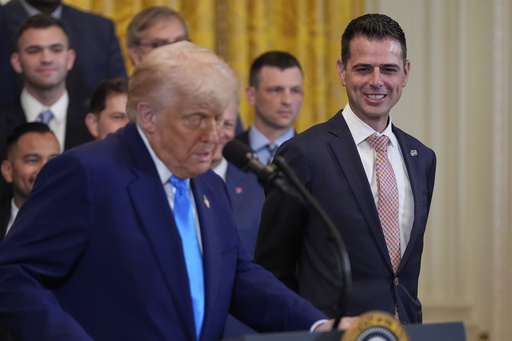 President Donald Trump speaks as he hosts the 2025 NCAA Champion, University of Florida men's basketball team in the East Room of the White House, Wednesday, May 21, 2025, in Washington, as head coach Todd Golden, listens at right. (AP Photo/Julia Demaree Nikhinson)