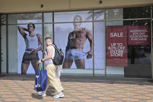 FILE - Shoppers walks past a Calvin Klein store at Citadel Outlets in Commerce, Calif., April 14, 2025. (AP PhotoDamian Dovarganes, file)