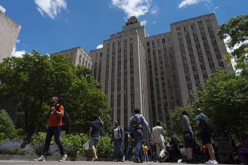 FILE - People walk by the Manhattan Criminal Court building, Wednesday, May 29, 2024, in New York. (AP Photo/Julia Nikhinson, File)