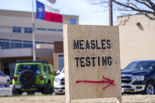 FILE - A sign is seen outside of Seminole Hospital District offering measles testing, Feb. 21, 2025, in Seminole, Texas. (AP Photo/Julio Cortez, File)